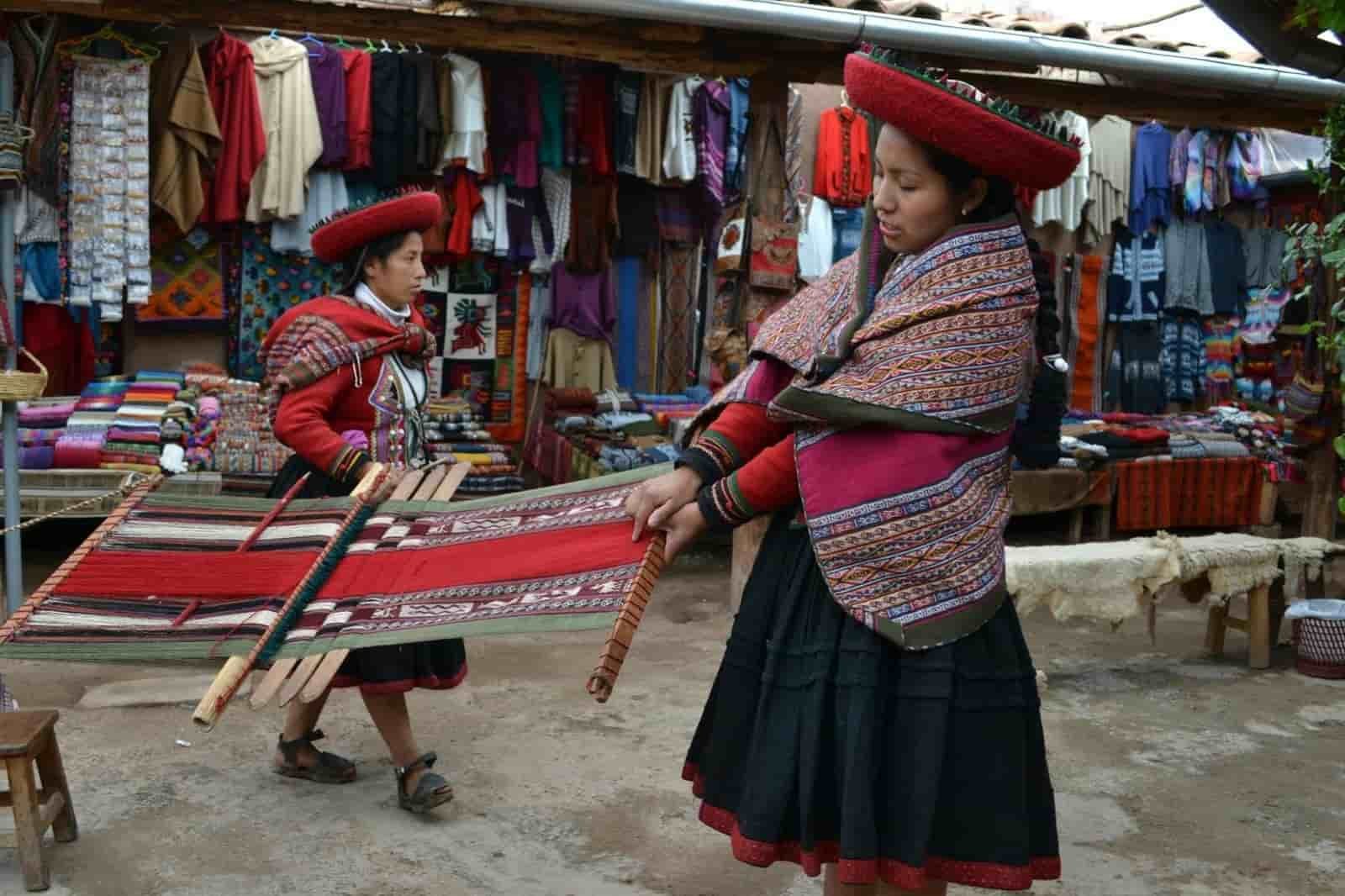 Women weaving traditional textiles in the Sacred Valley of Cusco, Peru, showcasing the vibrant Andean culture and craftsmanship.